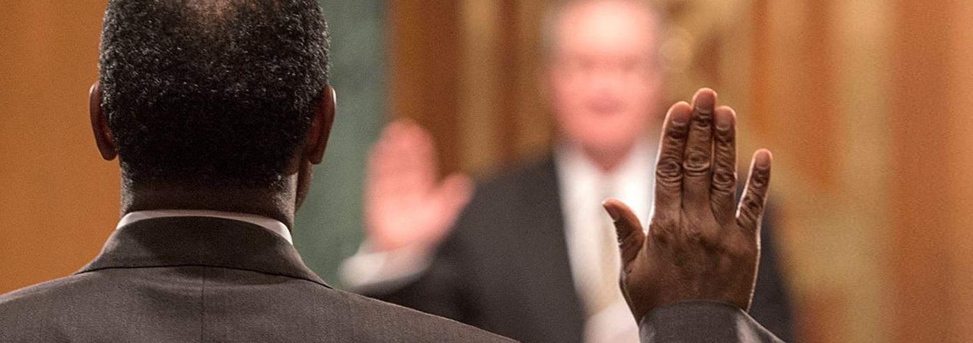 Man holding up his hand with judge