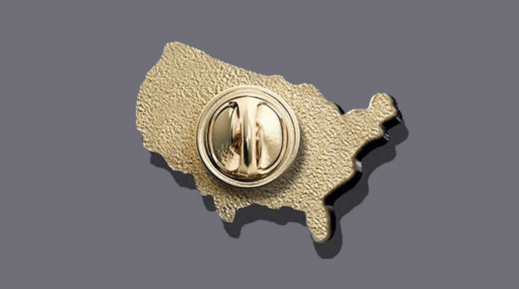 The back of a gold pin in the shape of the United States