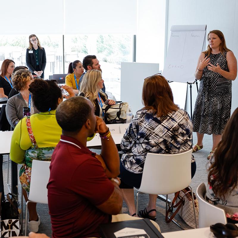 People listening to a person giving a talk