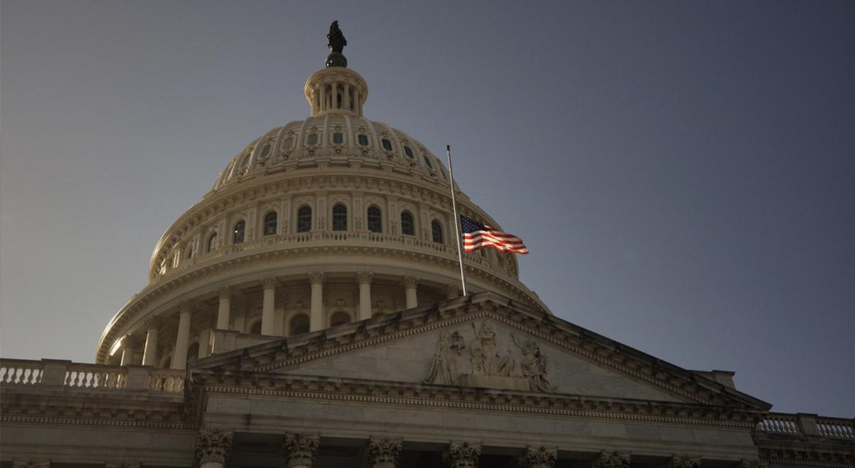 U.S. Capitol building dome with American flag flying.
