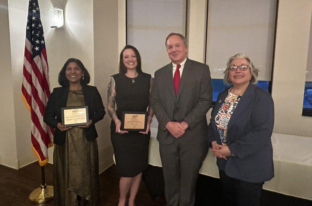 Diverse group of people holding awards